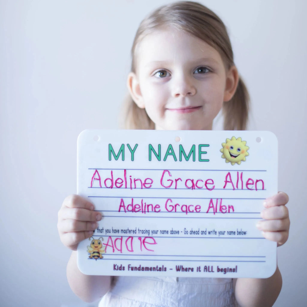 Preschool aged girl holding her board after handwriting practice on the Name Tracing Handwriting Board