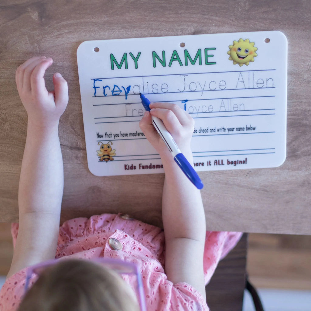 Preschool aged girl actively doing handwriting practice on the Learn To Write Your Name Handwriting Board - Kids Fundamentals