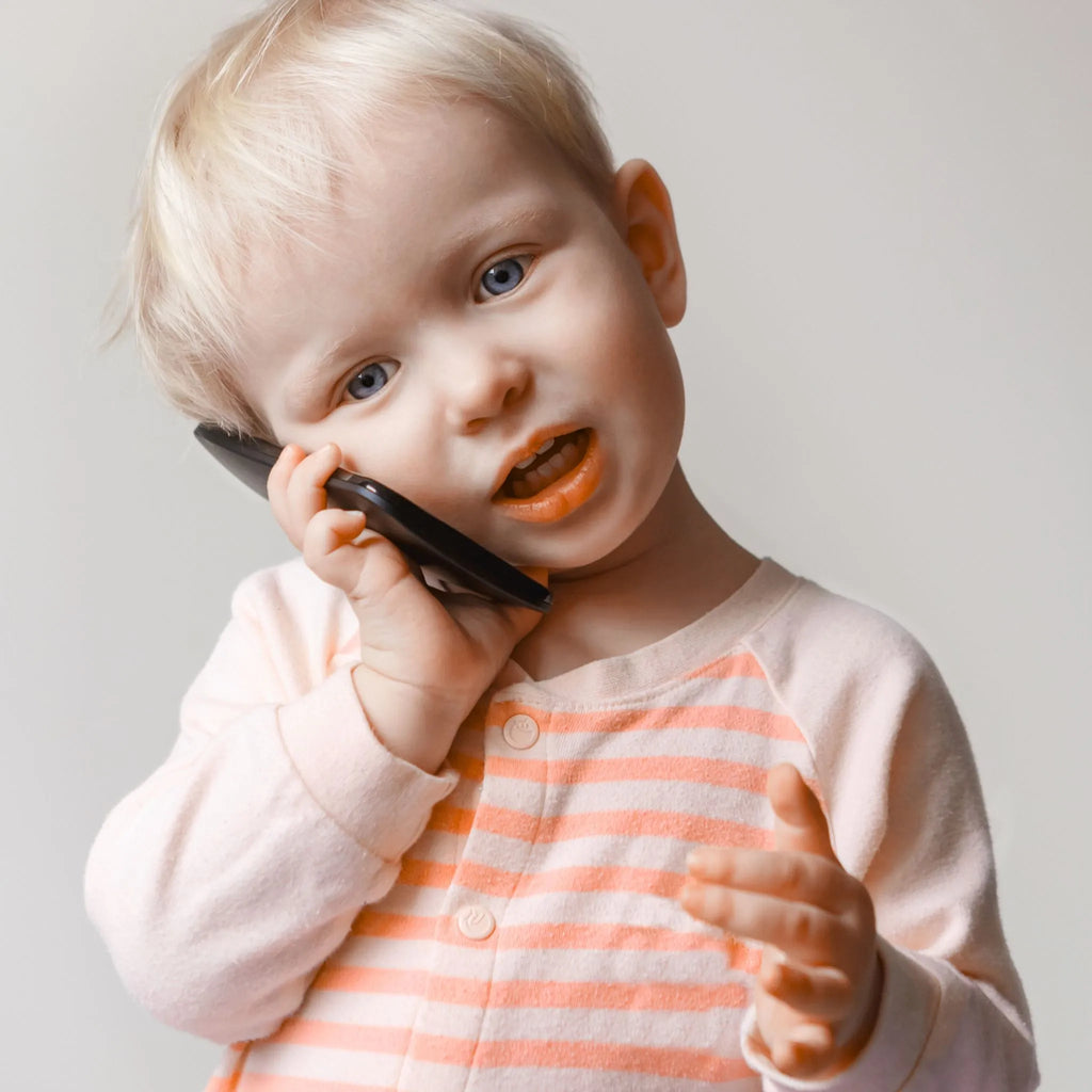 Child pretending to talk on a cell phone